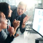 People seeing a AMS in front of a computer